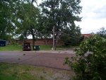 This power pole snapped right in the middle. The top half is just standing, held up by the tension in the wires.  There's a minivan to the left right under the lines.
